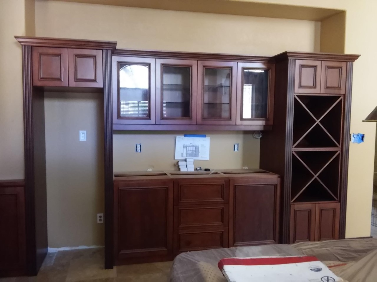 A kitchen with wooden cabinets and wine racks.