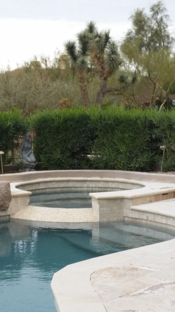A pool with a statue of a person in the middle.