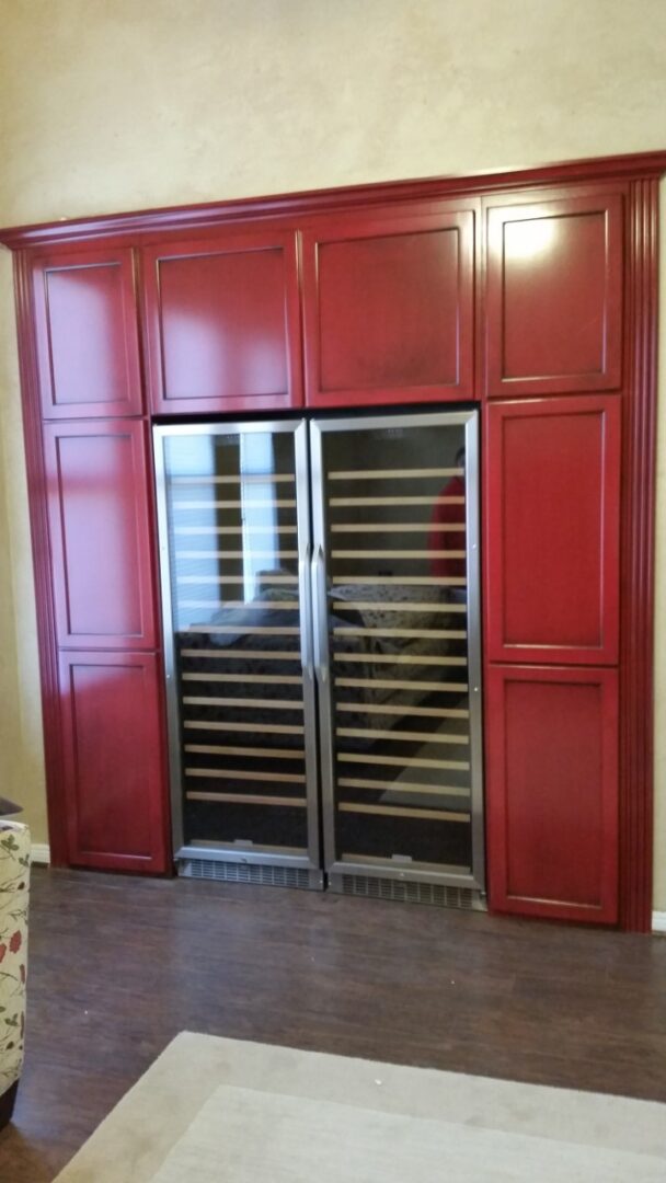A large red cabinet with two stainless steel doors.